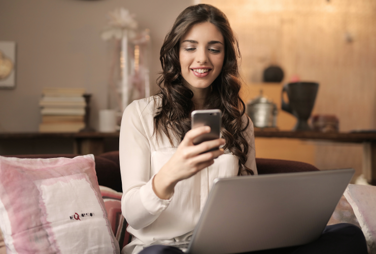 Woman sat down looking at her phone