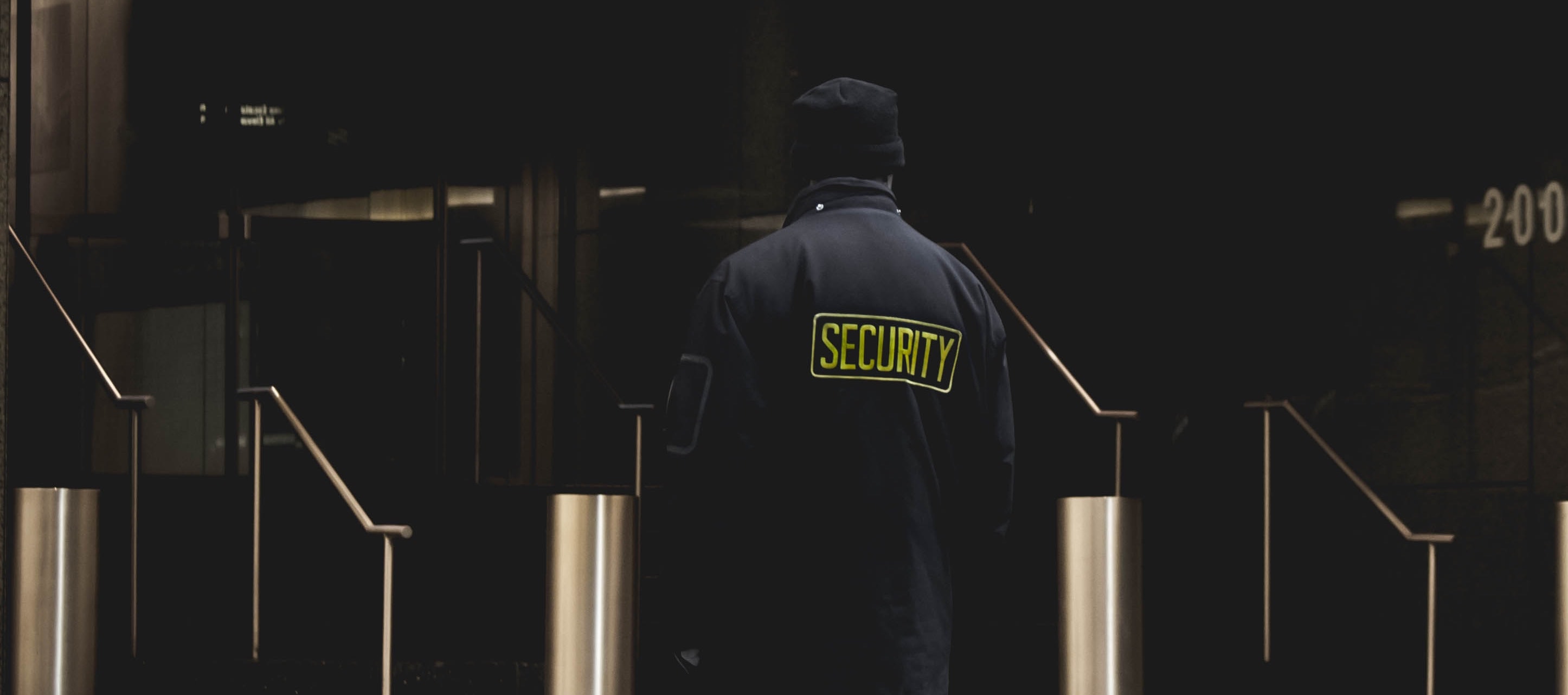 Security guard in front of building entrance